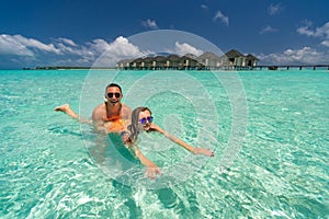 Young happy couple on tropical beach at summer vacation