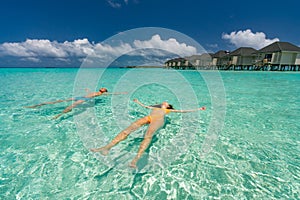 Young happy couple on tropical beach at summer vacation