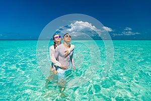 Young happy couple on tropical beach at summer vacation