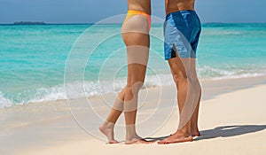 Young happy couple on tropical beach at summer vacation