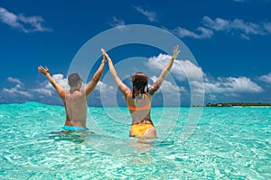 Young happy couple on tropical beach at summer vacation