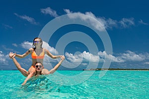 Young happy couple on tropical beach at summer vacation