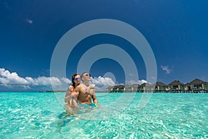 Young happy couple on tropical beach at summer vacation