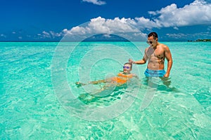 Young happy couple on tropical beach at summer vacation