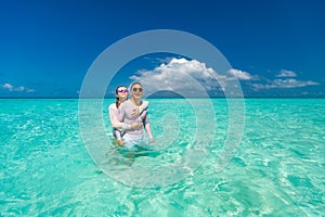 Young happy couple on tropical beach at summer vacation