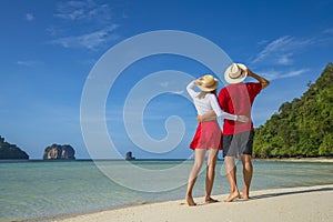 Young happy couple on tropical beach at summer vacation. Thailand