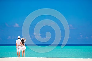 Young happy couple on white beach at summer