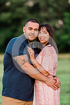 Young happy engaged couple outside in the evening