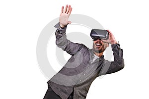 Young happy and excited man wearing virtual reality VR goggles headset experimenting 3d illusion playing video game touching