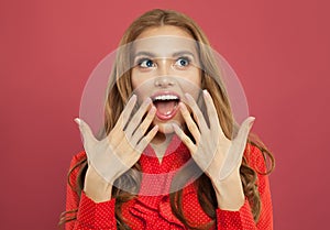 Young happy excited surprised woman with opened mouth on colorful bright pink background. Positive emotion.