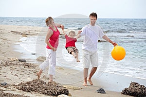 Young happy family on the beach