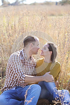 Young happy family couple rest outdoor, looking at camera