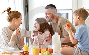 Young happy family eating morning breakfast together at home