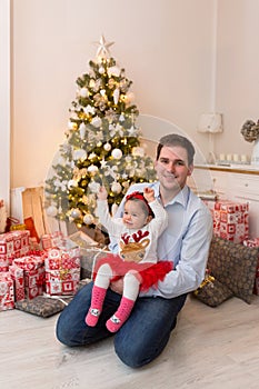 Young happy family in front of a Christmas tree