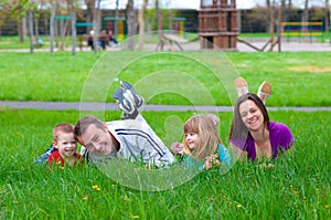 Young happy family having fun in the grass