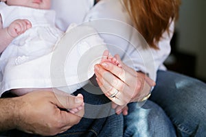 Young happy family holding a newborn baby