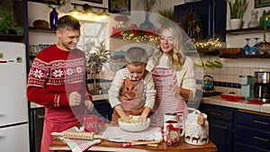 Young happy family kid dancing having fun together preparing Christmas dinner