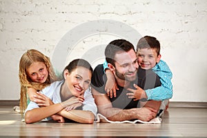 Young happy family parents and two children home studio