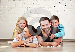 Young happy family parents and two children home studio