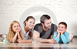 Young happy family parents and two children home studio