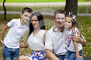 Young happy family portrait on background of the autumn park