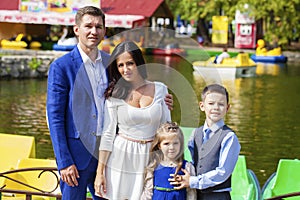 Young happy family portrait on background of the autumn park