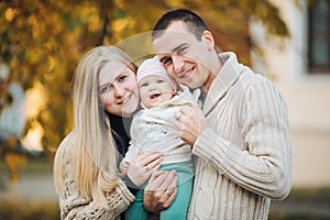 Young happy family smiling at camera and standing together.