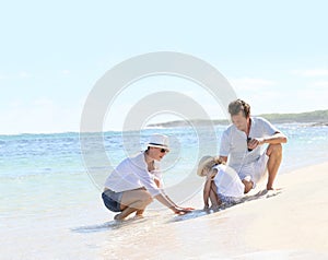 Young happy family spending time on the beach