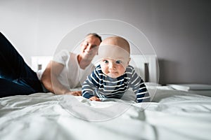 Young happy father have fun time with his baby at home