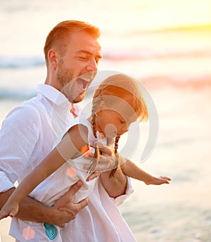 Young Happy Father having fun with his Little Daughter