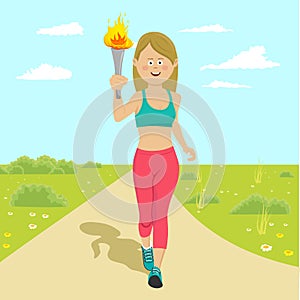 Young happy female athlete holding a fire torch running outdoor