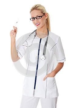 Young happy female doctor holding syringe