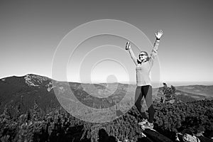 Young happy female hiker at the mountain top