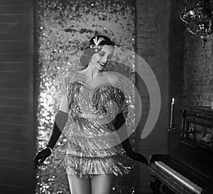 Young happy flapper beautiful woman. Black and white photo. Style roar Party 20s photo