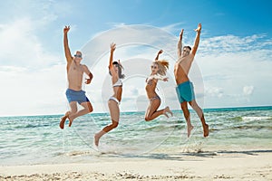 Young happy friends havin fun on the beach