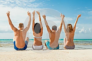 Young happy friends havin fun on the beach