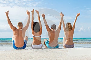 Young happy friends havin fun on the beach