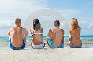 Young happy friends havin fun on the beach