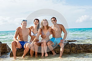 Young happy friends havin fun on the beach