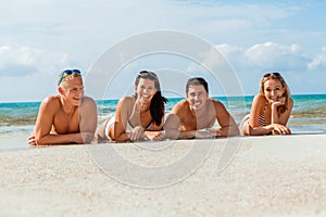 Young happy friends havin fun on the beach