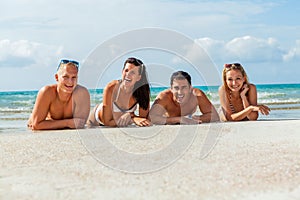 Young happy friends havin fun on the beach