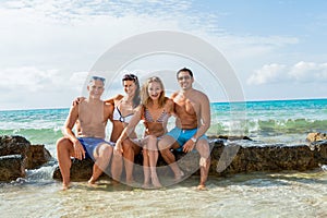 Young happy friends havin fun on the beach