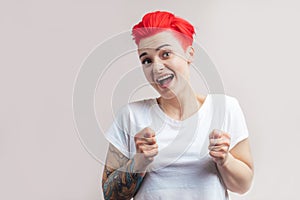 Young happy funny woman showing fico, isolated on white background