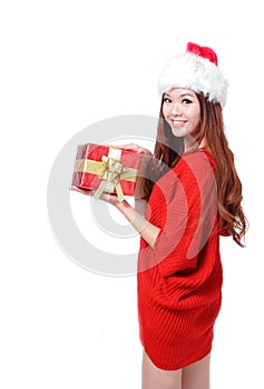 Young happy girl in Christmas hat holding gift
