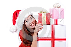 Young happy girl in Christmas hat holding gift