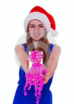 Young happy girl in Christmas hat and holding gift