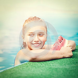 Young happy girl eating watermelon in pool