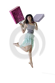 Young happy girl jumping with her shopping parcels