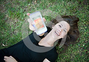 Young happy girl laughing at phone