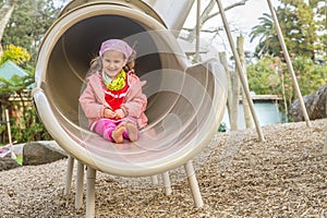 Young happy girl playing on playground